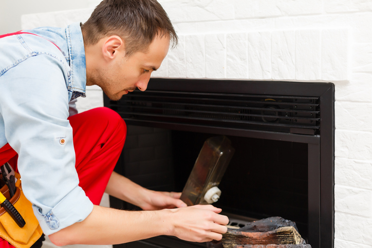 Fireplace Repair Service Technician repairing fireplace in the house